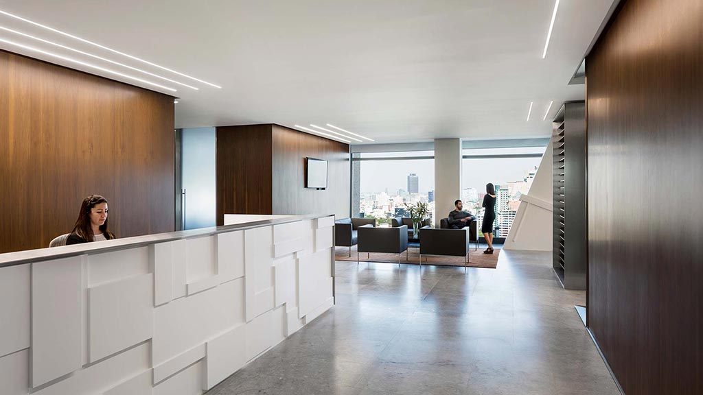 A person sitting at a desk in a large office.