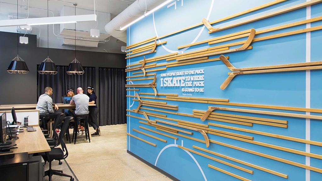 A group of people sitting at a table in a room with blue walls.