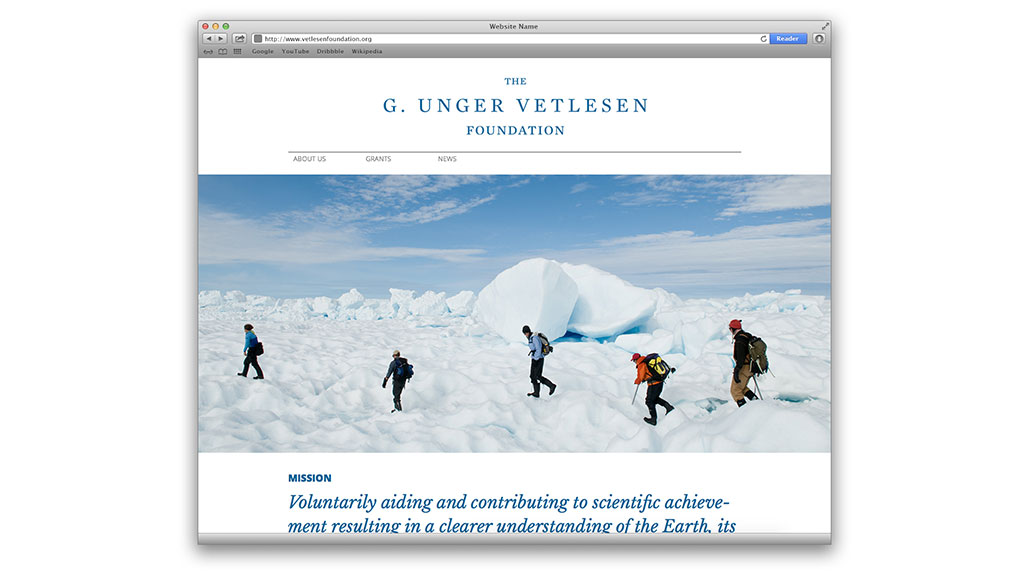 A group of people hiking up a snowy mountain.