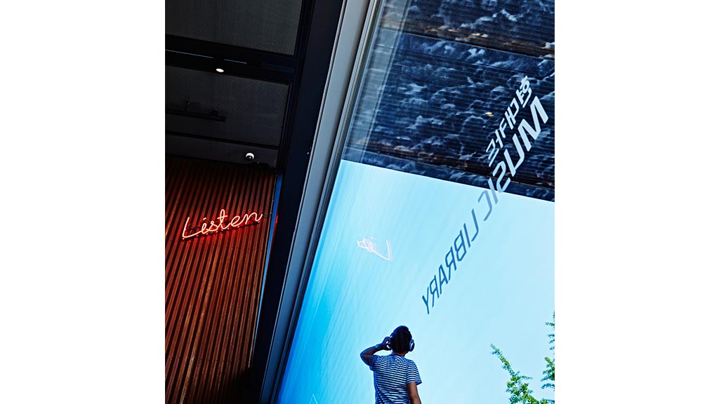 A man looking at a large screen.