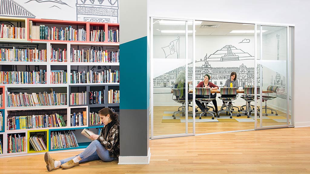 A group of people sitting in a library.
