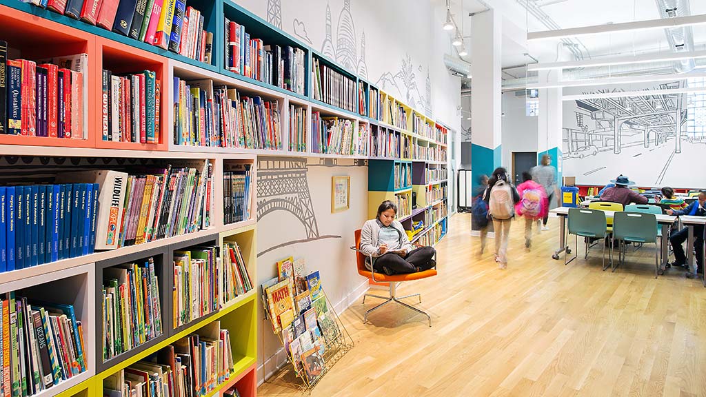 A person sitting in a chair in a library.