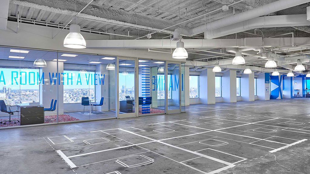 A large empty building with blue doors.