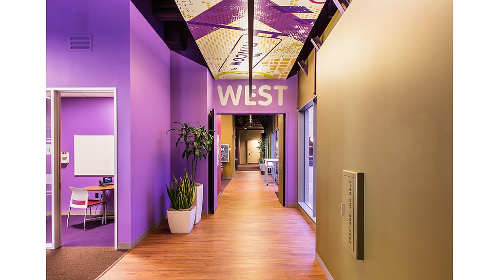 A hallway with a wood floor.