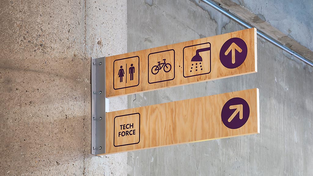 A street sign on a wall.