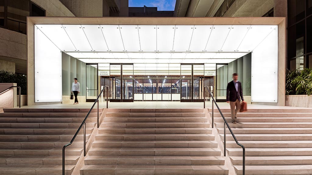 A couple of people walking up stairs.