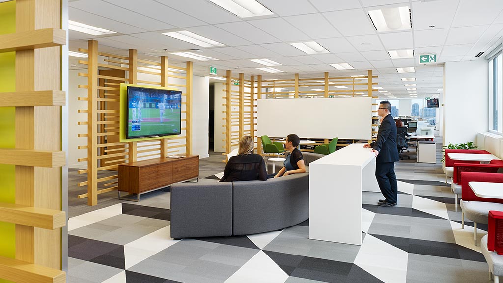 A man and a woman in a room with a tv and a couch.