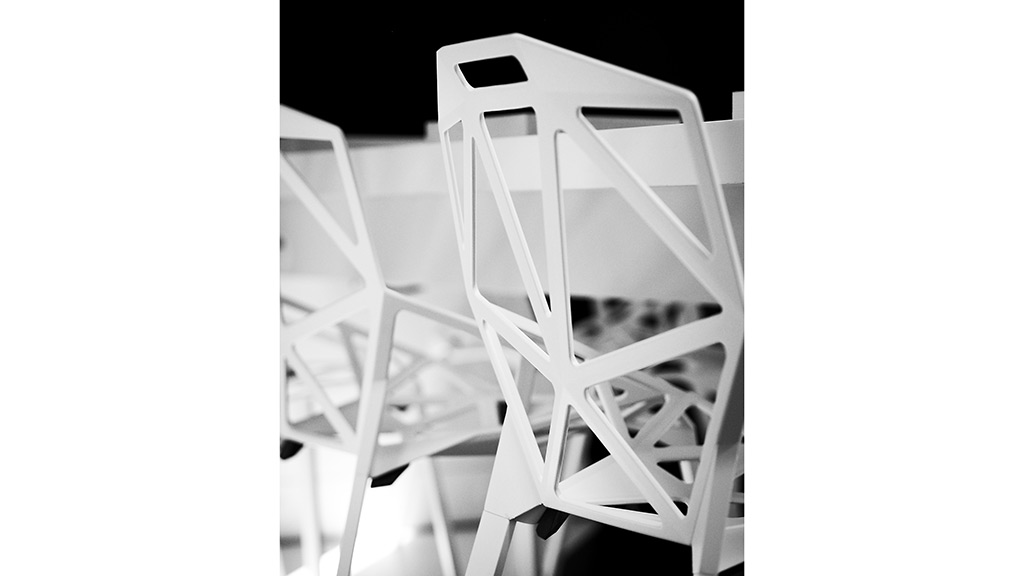 A white chair with a black background.