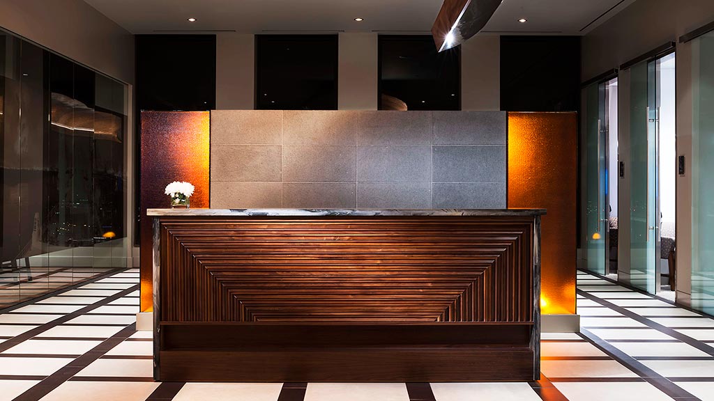 A large room with a wood bench.