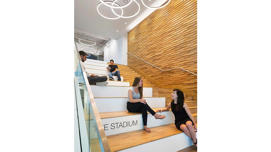 A group of people sitting on stairs.
