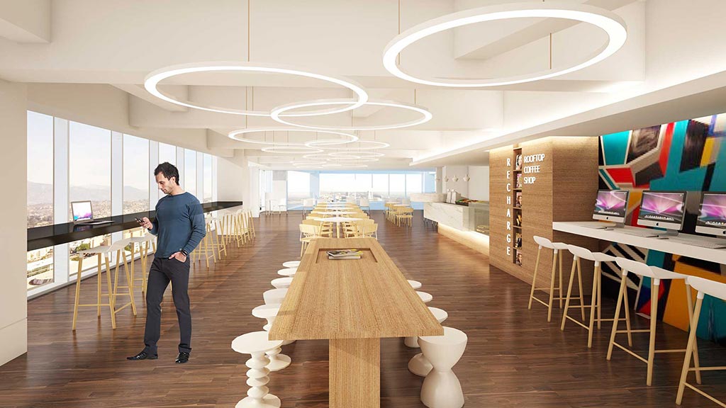 A person standing in a room with tables and chairs.