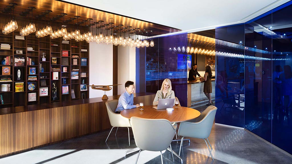 A man and woman sitting at a table in a restaurant.
