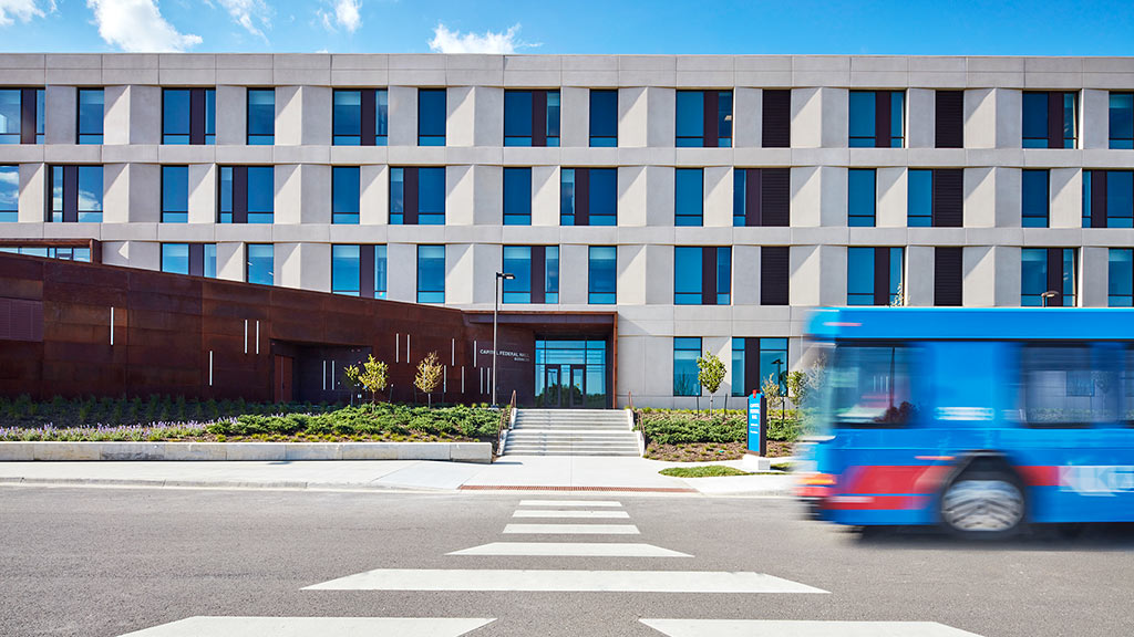 A bus parked in front of a building.