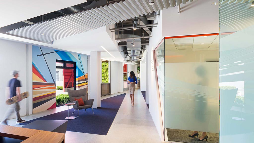 A man and woman walking through a building.