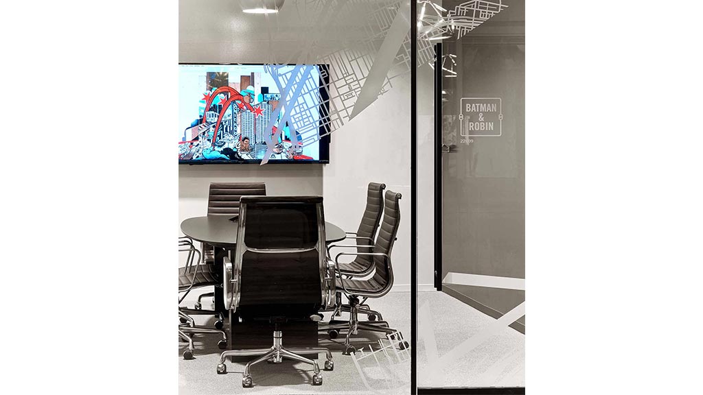 A room with chairs and a tv.