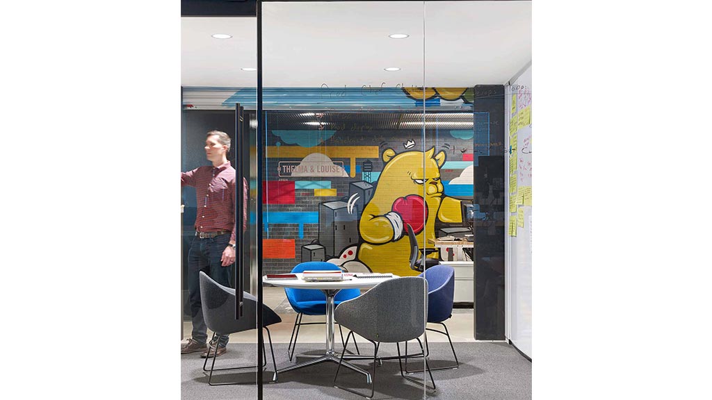 A person standing next to a table.