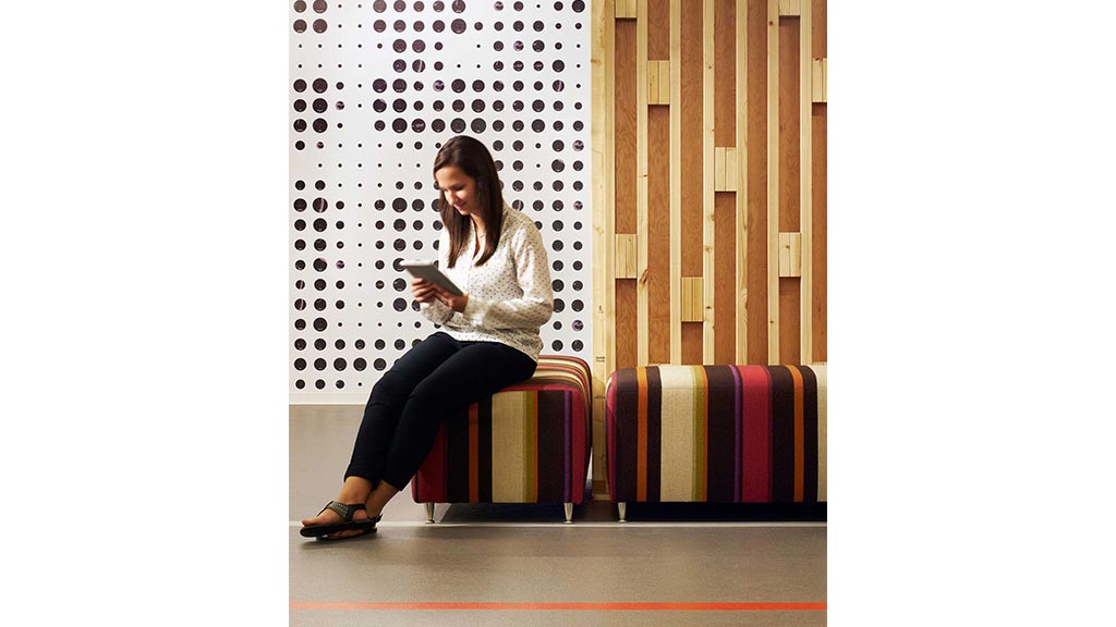 A woman sitting on a stool.