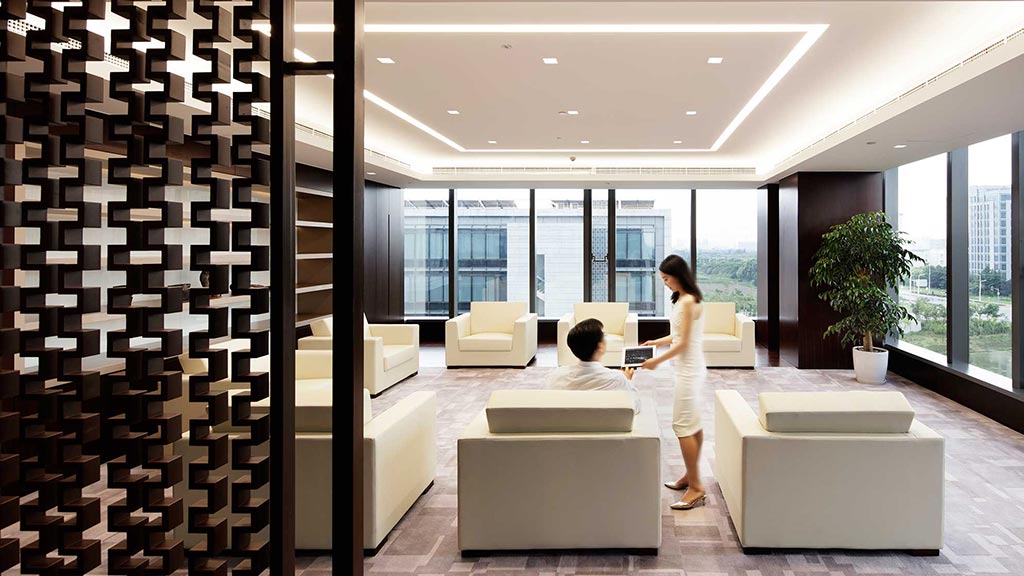 A woman and a man looking at a laptop.