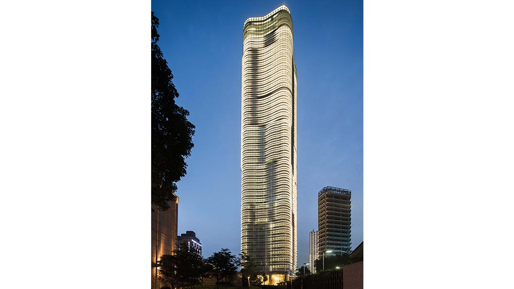 A tall building with a glass front.