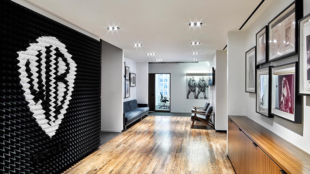 A hallway with a wood floor.