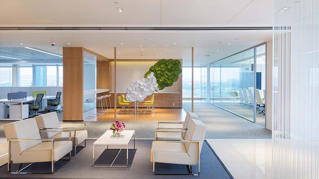 A room with a large glass wall and a large table with chairs.