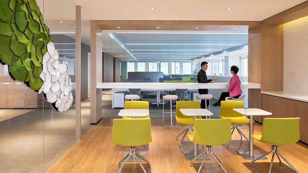 A couple of people in a room with tables and chairs.