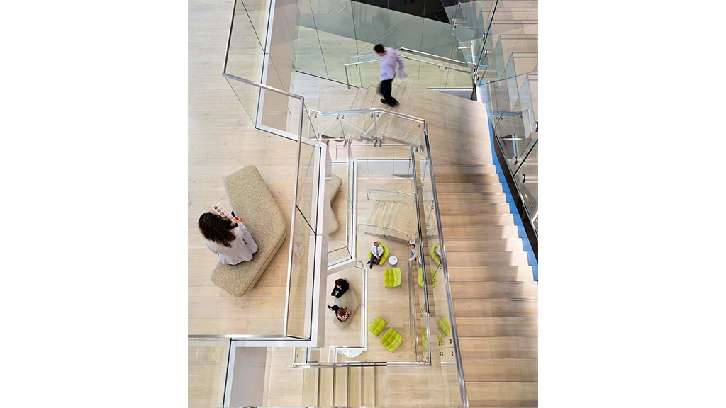 A man looking at a woman in a glass room.