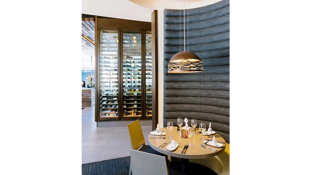 A dining room with a table set.