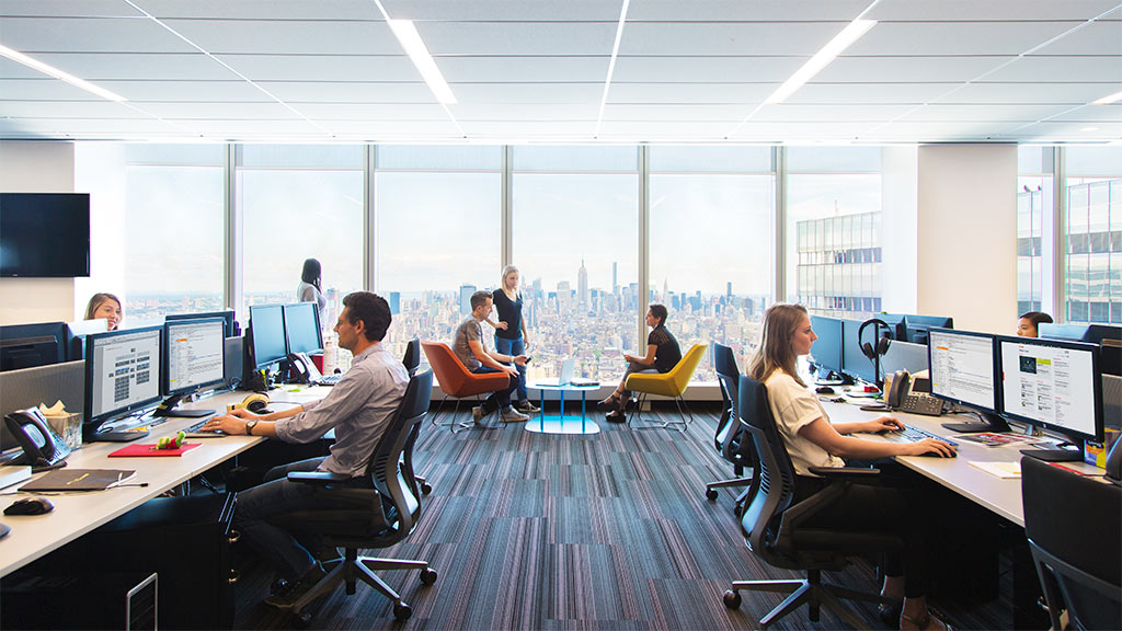 A group of people sitting at computers.