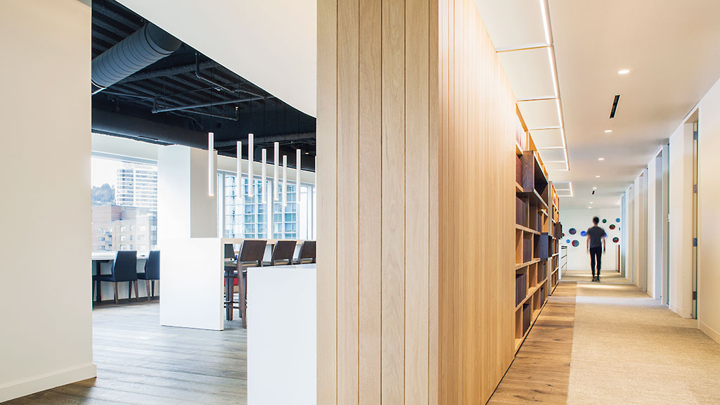 A long hallway with a person walking.