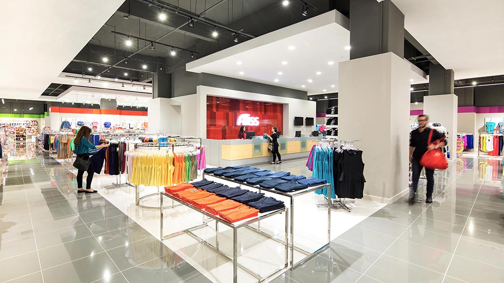 A large room with a few people.