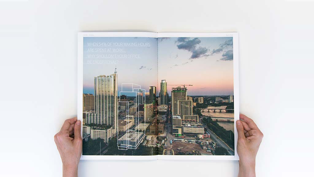 A person holding a picture of a city.