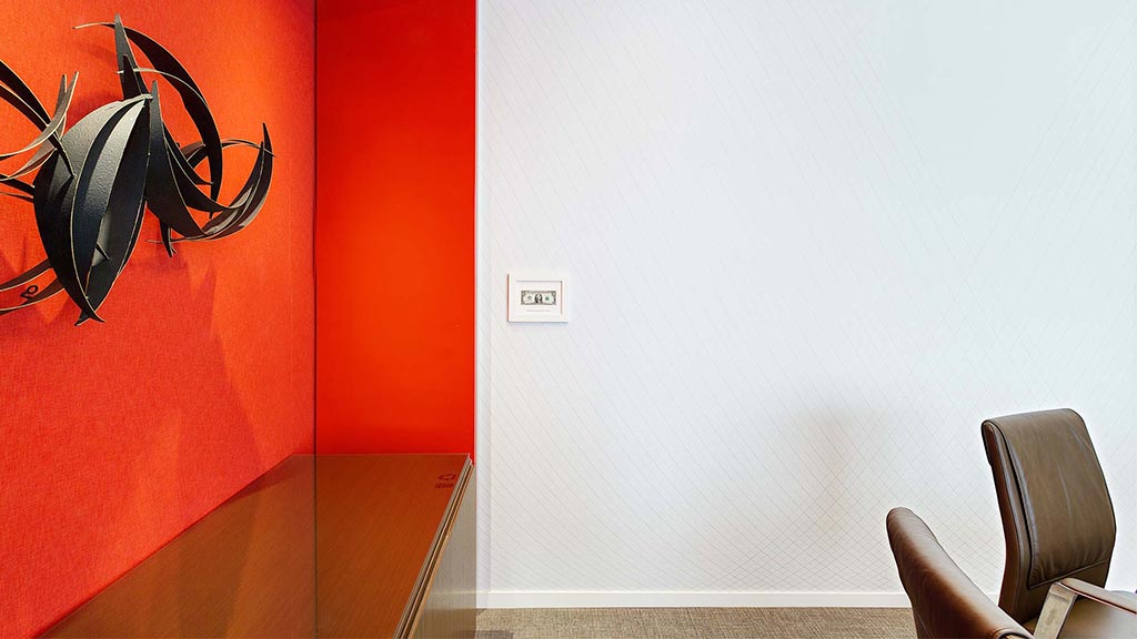 A white wall with a red and orange wall.