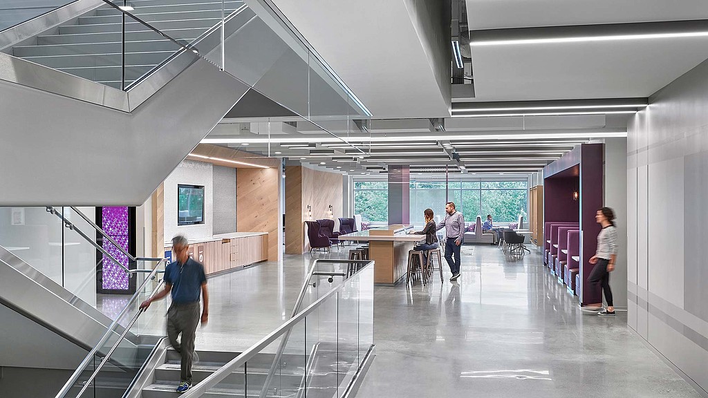 People in a room with glass walls.