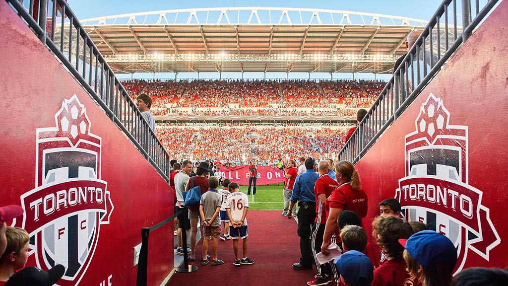 A group of people standing in a stadium.