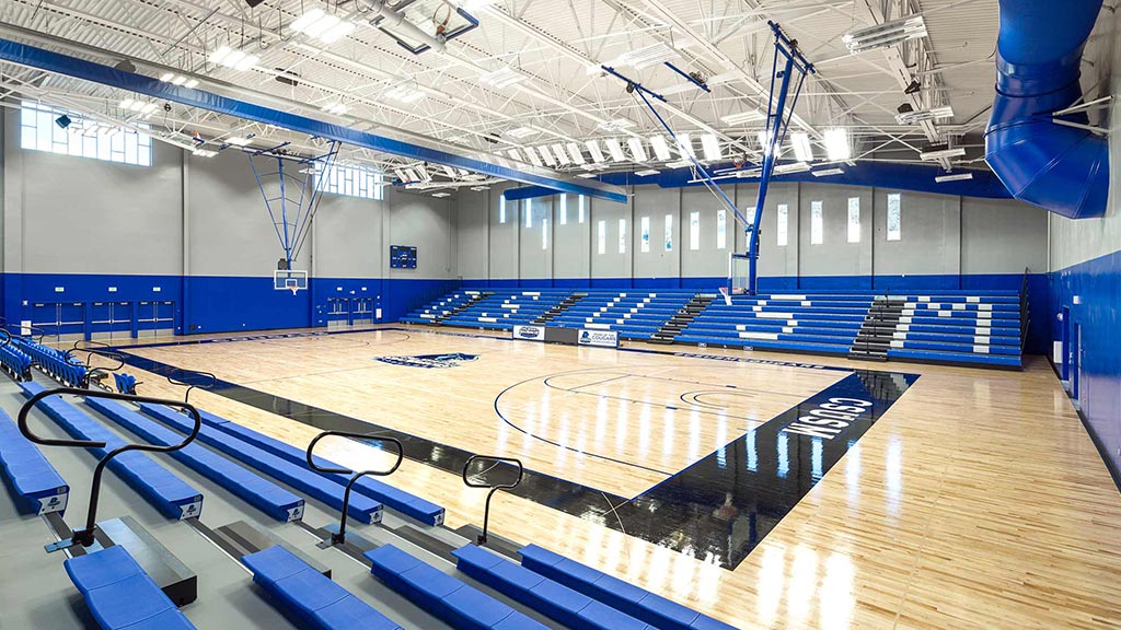 A gym with blue seats.