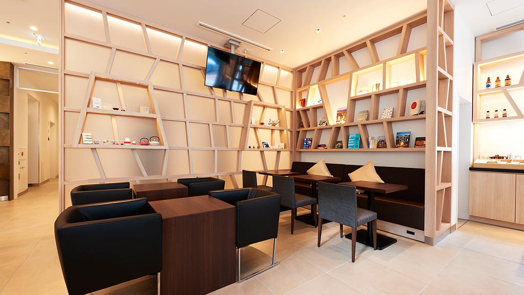 A room with a tv and chairs.