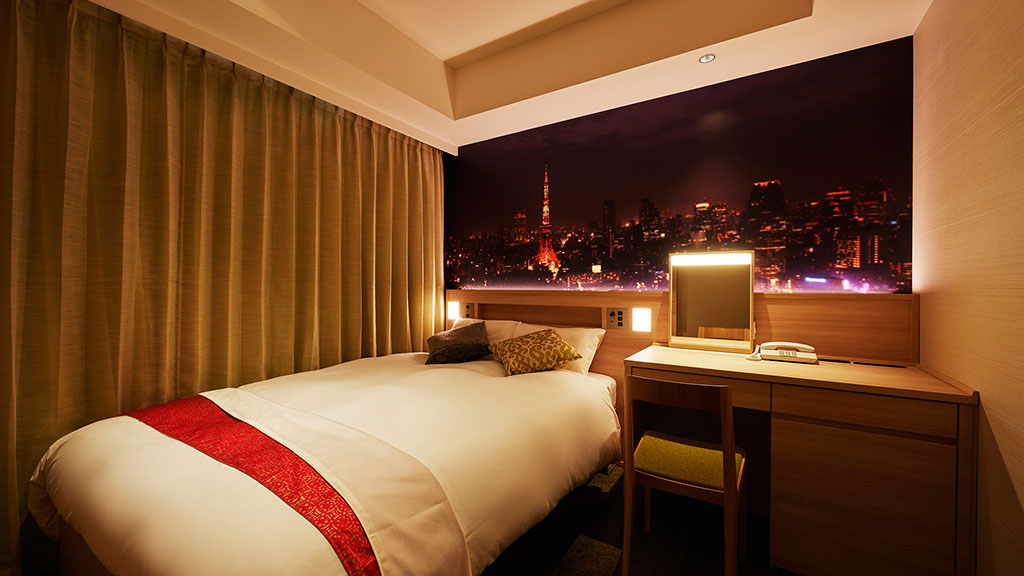 A bedroom with a bed and a desk.