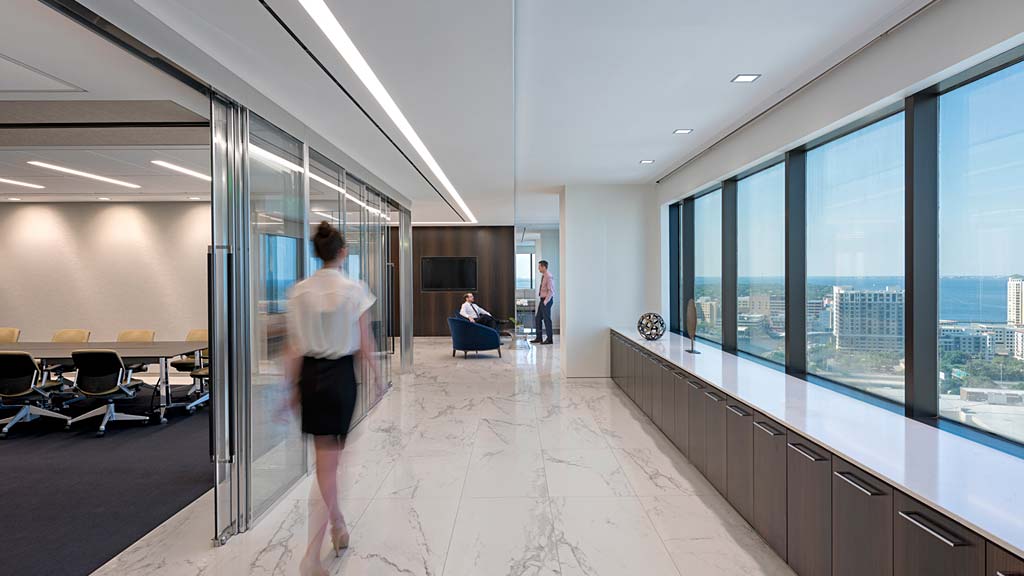 A person walking in a large office.