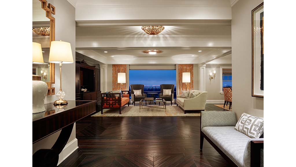 A large living room with a wood floor.