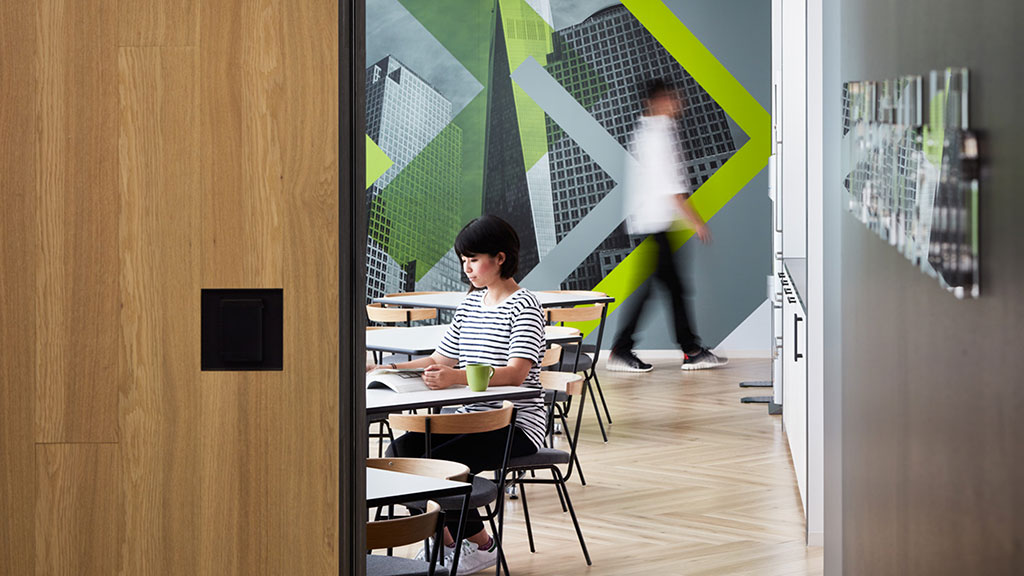 A boy sitting at a desk in a classroom.