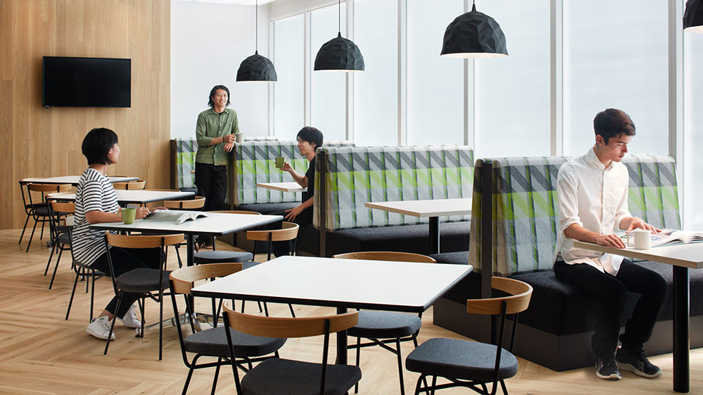 A group of people sitting at tables.