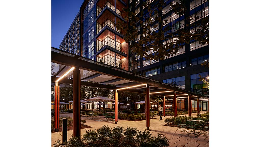 A building with a walkway and plants.