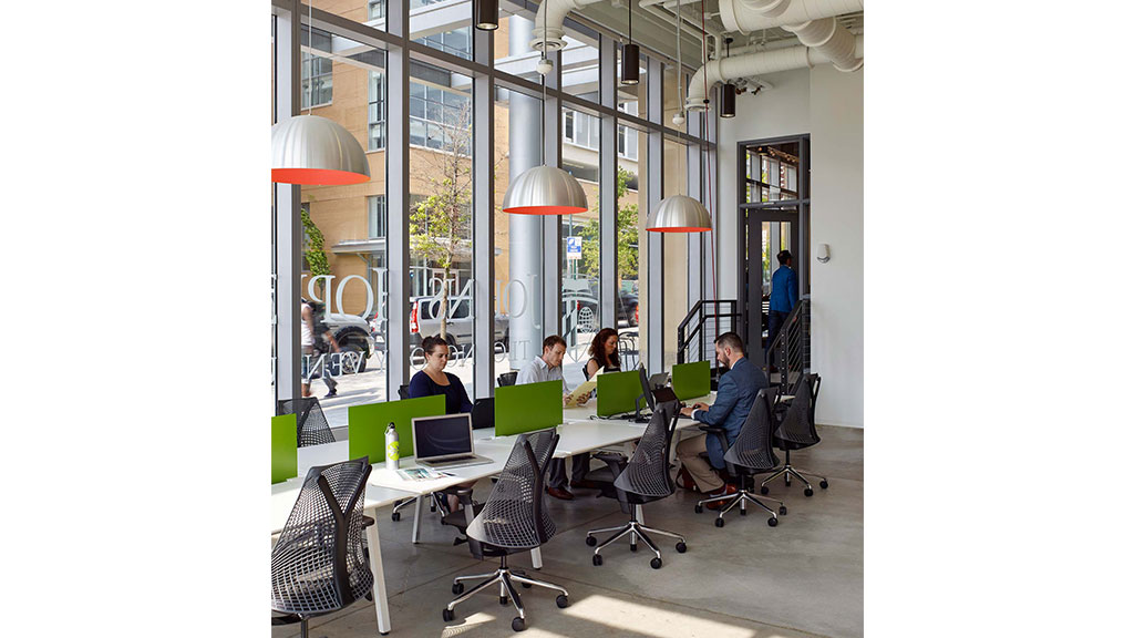 People sitting at a table with laptops.