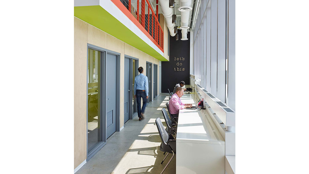 A few people walking down a sidewalk.