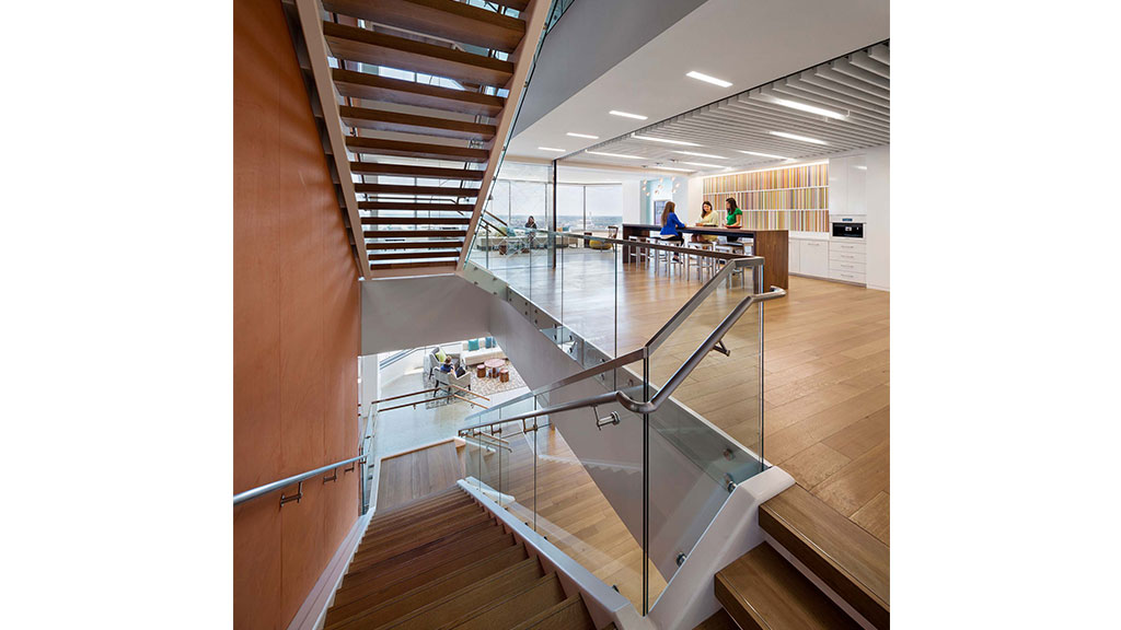 A large room with a glass staircase.