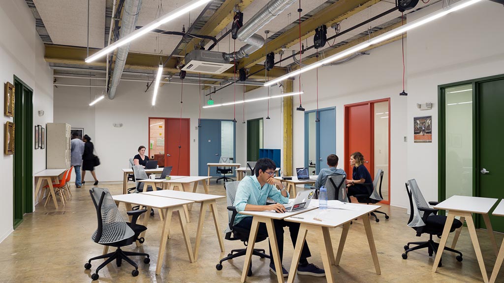 People sitting at tables in a room.