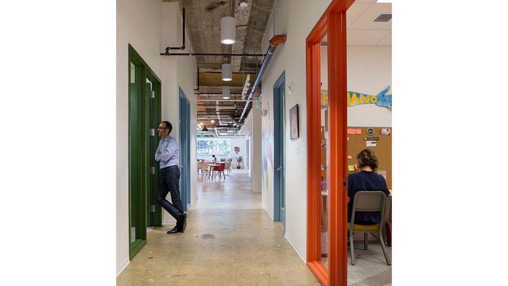 A person standing in a hallway.