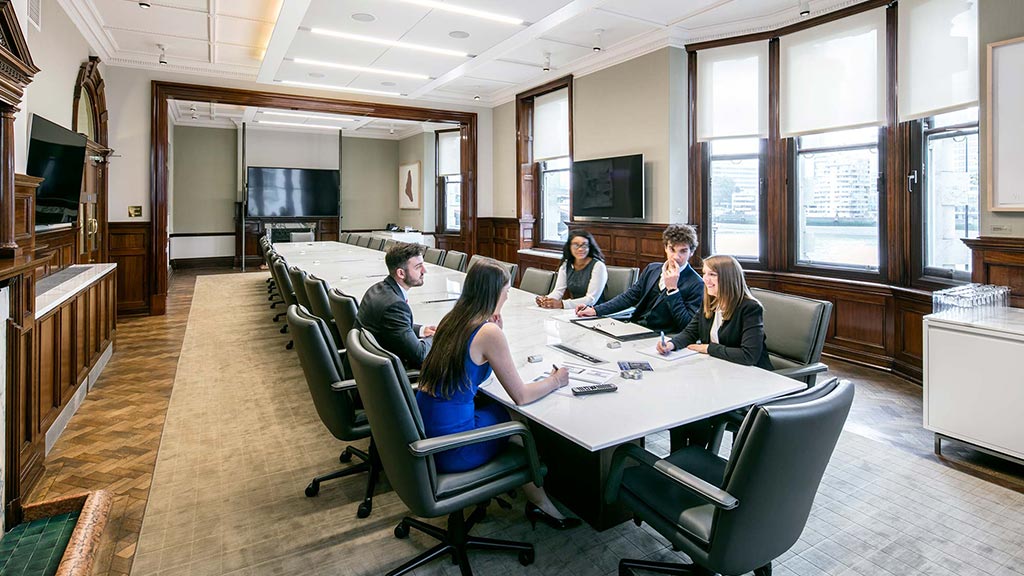 A group of people sitting around a table.