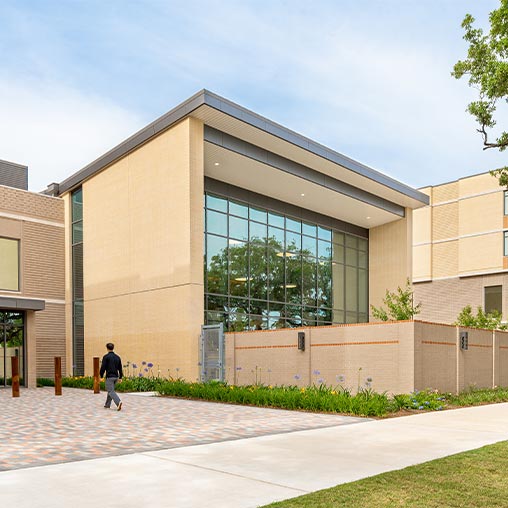 A person walking outside of a building.